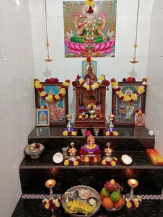 there is a small shrine with fruits and candles