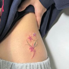 a woman's thigh with a flower tattoo on it