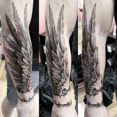 a man's leg with black and grey tattoos on it, showing the wings