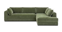 a green sectional couch with pillows on it's back and the seat folded out