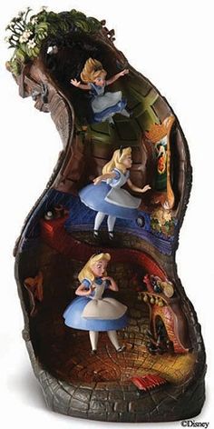 a figurine with alice and wonderland characters on it