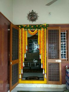 an entrance to a house decorated with flowers and garlands