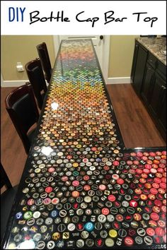 a long table covered in lots of different colored bottle caps on top of a wooden floor