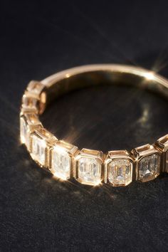 an antique diamond ring on a black surface