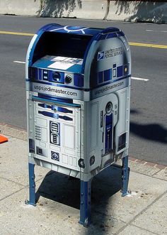 a star wars mailbox sitting on the sidewalk