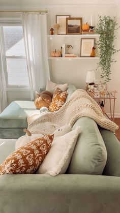 a living room filled with lots of furniture and pillows on top of it's couches