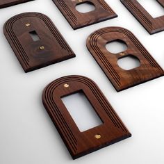 eight wooden switchplates are arranged on a white surface