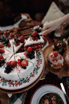 a table topped with cakes and desserts covered in frosting