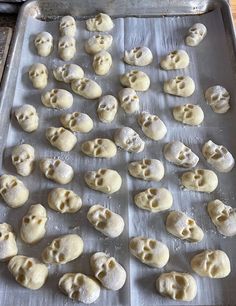 a pan filled with dough covered in skulls