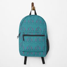 a blue backpack hanging on a wall with an earring attached to the back pocket