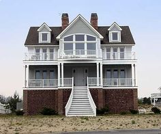 a large white house sitting on the side of a road