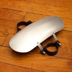 a close up of a skateboard on a wooden floor with it's handle missing