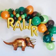 an animal balloon garland with the word railr spelled out in gold, green, and orange balloons