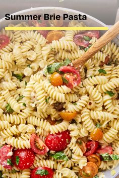 a white bowl filled with pasta and tomatoes