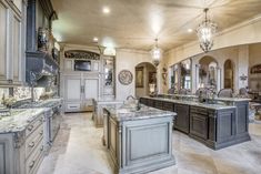 a large kitchen with marble counter tops and an island