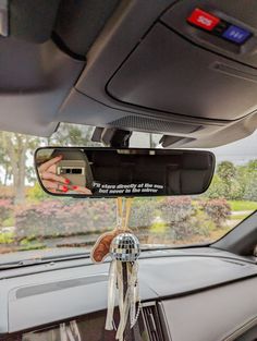 the interior of a car with a mirror hanging from it's ceiling