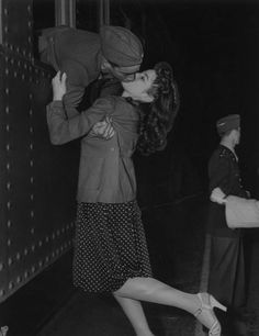 an old photo of a woman kissing a man