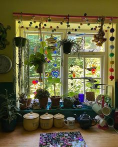 there are many potted plants on the window sill in this room, and one is filled with books