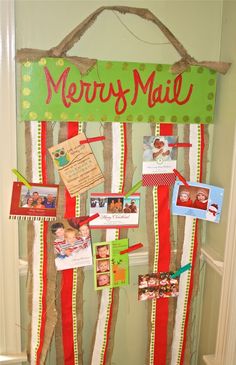 a merry mail sign hanging from the side of a door with pictures and magnets on it