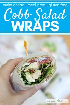 a hand holding a wrap filled with meat and lettuce