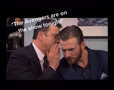 two men sitting next to each other in front of a tv screen with the caption saying, the avengers are on the show tonight