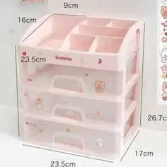 three drawers with hello kitty stickers on the top and bottom, each containing different items