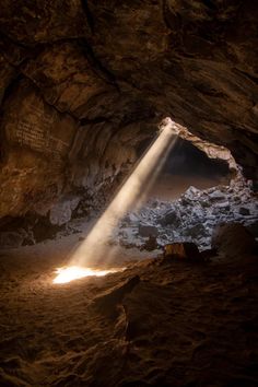 the light is shining into a cave