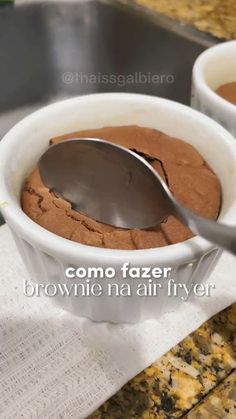 two white bowls filled with chocolate pudding on top of a counter