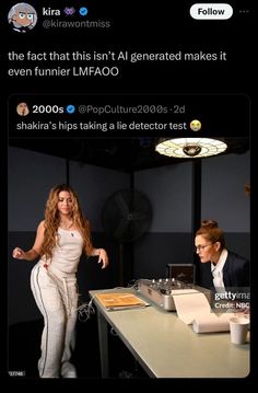 two women standing in front of a table with laptops