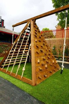 a wooden climbing frame in the grass