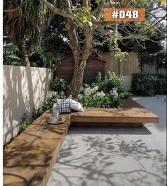 a wooden bench sitting in the middle of a garden