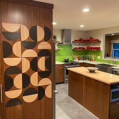 a kitchen with green walls and wooden cabinetry in the center, along with an island