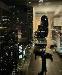 the city lights are reflected in the glass windows on the building's roof top