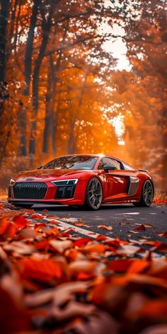 a red sports car parked on the side of a road in front of some trees