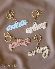 four personalized keychains with names on them