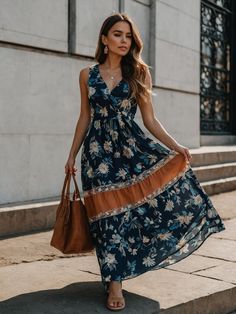 A navy blue maxi dress captures the essence of nautical romance with its bold floral patterns set against a deep blue oceanic backdrop. The contrasting orange belt detail accentuates the waist, while the flowing skirt moves with a grace that mimics the sea’s own rhythms. Perfect for a day by the water or a casual outing, it’s a dress that combines the allure of the high seas with springtime flair. Orange Belt, Navy Blue Maxi Dress