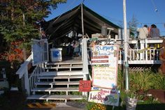 people are standing on the porch of a house that has been decorated with signs and decorations