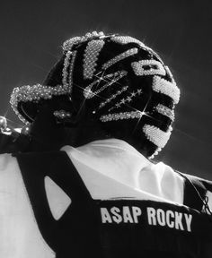 black and white photograph of the back of a hockey goalie's helmet with words ascap rocky written on it