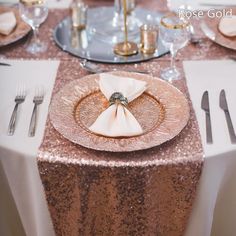 the table is set with silver and gold place settings