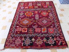 a large red rug on the floor in a room