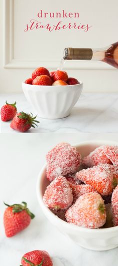 powdered sugar covered strawberries in a white bowl on a marble counter top next to a bottle of wine