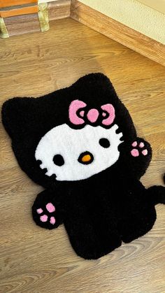 a black hello kitty rug on the floor