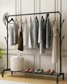 an iron rack with clothes and shoes hanging on it