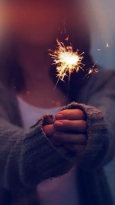 a person holding a sparkler in their hand