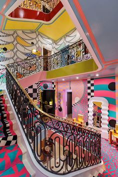 the stairs in this room are decorated with colorful wallpapers and geometric designs on them