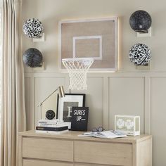 Score a slam dunk! Our wall-mounted decorative basketball hoop is crafted of wood with an iron hoop and a cool backlit backboard that brings a dose of courtside drama to your bedroom. Made of MDF, iron and nylon netting. Mounting hardware included; 2 anchors and 2 screws. Mounts vertically. This is not a toy, it's for decorative purposes only. Imported. Mirror In Boys Room, Toys As Decor, Basketball Hoop Room Decor, Sports Nursery Theme Vintage, Kids Soccer Room Ideas, Modern Sports Room, Wooden Basketball Backboard, Crib And Bed Shared Room