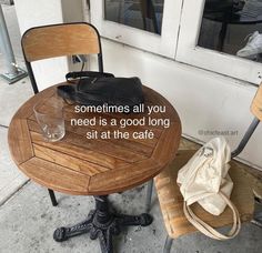 a wooden table sitting next to a chair on top of a sidewalk