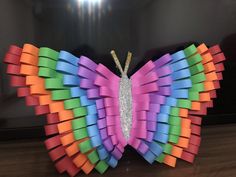 a colorful butterfly made out of colored paper