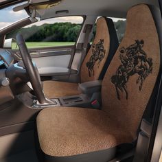 the interior of a car with two horses on it's seat covers and steering wheel