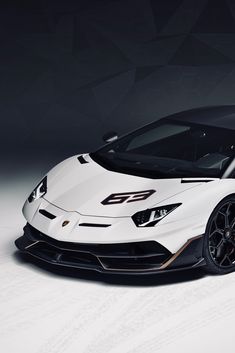 a white sports car parked in front of a black background